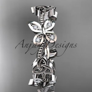 Puede incluir: Un anillo de banda de plata con un dise&ntilde;o de nudo celta y peque&ntilde;os diamantes engastados en la banda. El anillo presenta un dise&ntilde;o floral con hojas y una mariposa.