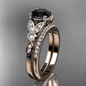 May include: A rose gold engagement ring set with a black diamond center stone and smaller diamonds set in a floral design.
