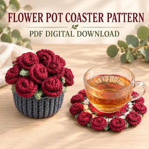 May include: A crochet flower pot coaster pattern PDF digital download featuring a dark gray crocheted pot filled with deep red roses and a matching circular coaster with red rose accents under a clear glass cup of tea.
