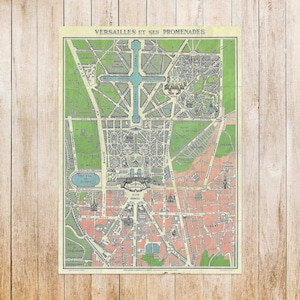 May include: A vintage map print of Versailles and its promenades, with a detailed layout in green, pink, and blue. The map includes French text, showing the city's layout and landmarks. The print is set against a wooden background.