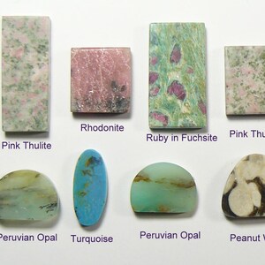 May include: A collection of eight polished gemstones including rectangular Pink Thulite, square Rhodonite, rectangular Ruby in Fuchsite, square Pink Thulite, two semi-circular Peruvian Opals, an oval Turquoise, and a triangular Peanut Wood piece next to a US dime.