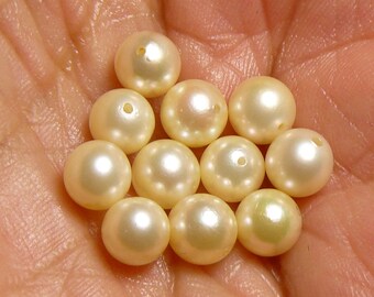 12 beautiful cultured (real) pearls. Used, taken from a 14k necklace.   Comes with 5 free pearls with missing nacre at the holes (m63041)