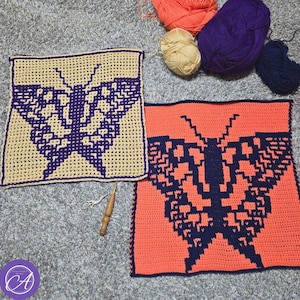 May include: Two square crochet panels featuring a dark purple butterfly motif. One panel has a beige background, and the other has a bright coral background. A wooden crochet hook and small metal scissors are placed between the panels, with balls of coral, beige, and purple yarn positioned above.