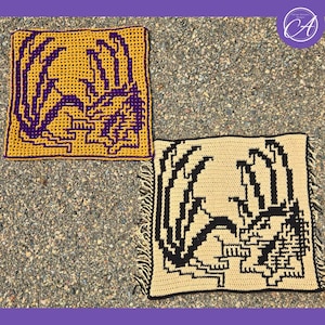 May include: Two crocheted squares with a dragon design. One square is yellow with a purple dragon, and the other is beige with a black dragon. The squares are handmade and have a textured appearance, suitable for home decor.
