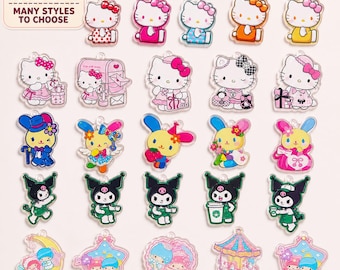 May include: A collection of twenty-five acrylic charms featuring Sanrio characters including Hello Kitty, Kuromi, and Little Twin Stars in various outfits and poses. The top left corner includes a sign reading SANRIO COLLECTION MANY STYLES TO CHOOSE.