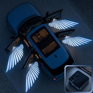 May include: A blue SUV with all four doors open, projecting bright white LED wing-shaped patterns onto the ground. An inset image shows a small, square, black carbon fibre-textured projector device with a lens and a side-mounted switch.