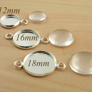 May include: Three silver-toned metal bezel settings for crafting jewelry. The bezels are 12mm, 16mm, and 18mm in diameter.