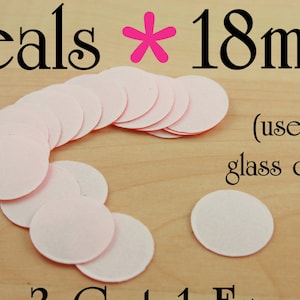 May include: A pile of 18 mm pink round paper seals. The text "Seals * 18mm (use with glass domes)" is visible in the image.