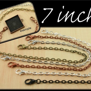 May include: Five 7-inch chain extenders in different colors: black, silver, copper, bronze, and antique brass. Each extender has a lobster clasp on one end and a jump ring on the other. The chains are all made of metal.