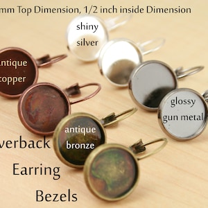 May include: Assortment of 12mm leverback earring bezels in various finishes, including antique copper, antique bronze, shiny silver, and glossy gun metal.