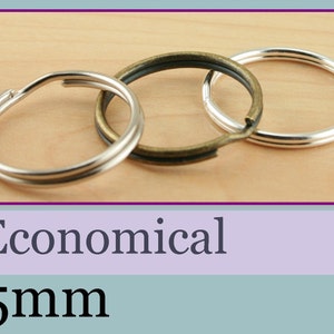 May include: Three key rings, one silver, one brass, and one silver with a brass finish, are shown on a wooden surface. The key rings are 25 mm in diameter. Economical.