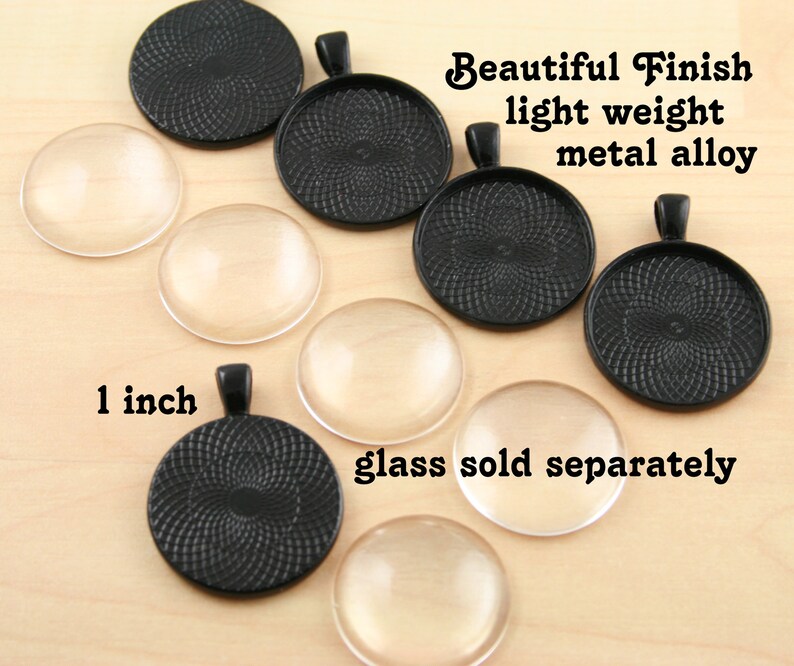 May include: A set of 1 inch black metal round pendant trays with a swirl design. The trays are made of a lightweight metal alloy and have a beautiful finish. Glass domes are sold separately.