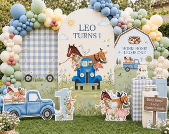 May include: A first birthday party backdrop featuring a blue truck, farm animals, and balloon arches in blue, green, and cream. Text includes LEO TURNS 1, HONK! HONK! LEO IS ONE, and Beep Beep! Leo's Farm Friends. Includes a tiered cake and floral decor.