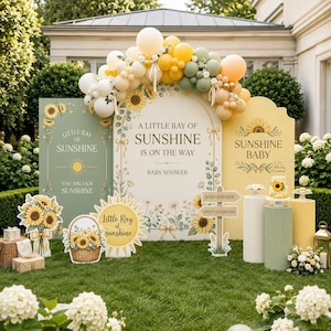 May include: A baby shower display featuring three arched panels in sage green, cream, and yellow with sunflower illustrations and the text A Little Ray of Sunshine Is On The Way. Includes a balloon arch, a sunflower cake, and signage.