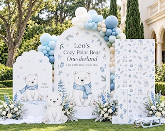 May include: A party backdrop set featuring three white arched panels with polar bear illustrations, blue and white balloon garlands, and a large number one sign. The text reads Leo's Cozy Polar Bear One-derland, Our Little Bear Turns One.