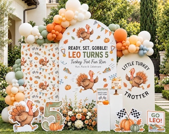 May include: A party backdrop set featuring three arched panels with turkey illustrations, pumpkins, and checkered flags. Text reads READY, SET, GOBBLE! LEO TURNS 5, Turkey Trot Fun Run, and LITTLE TURKEY TROTTER. Includes balloon garlands and a number 5 sign.