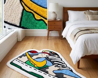 May include: A colorful, patterned rug shaped like a sneaker. The rug features a white border, green sole, and a design with blue, yellow, black, and white elements. It is placed on a wooden floor in a bedroom setting.