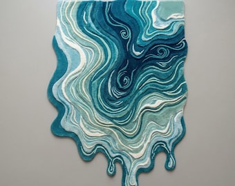 May include: A unique, abstract rug with a flowing, water-like design. The rug features shades of blue, teal, and white, creating a sense of depth and movement. The edges have a melted or dripping effect, adding to the artistic appeal. The rug's dimensions are not visible.