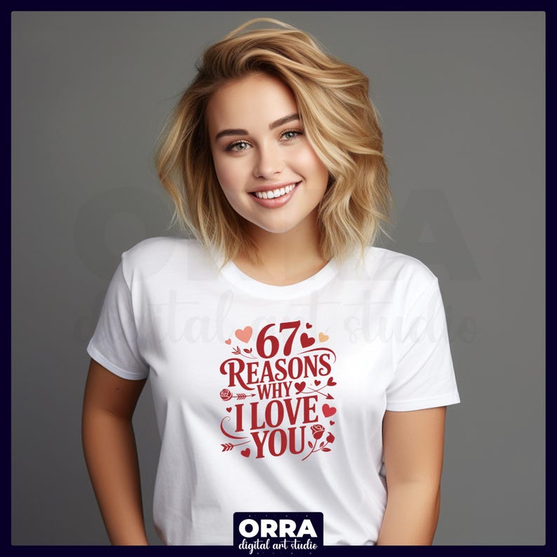 May include: White t-shirt with a red graphic that reads "67 Reasons Why I Love You." The design includes hearts, roses, and arrows. The shirt is worn by a person with blonde hair.