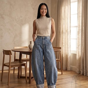 May include: A sleeveless beige mock neck top paired with high-waisted blue denim jeans featuring a wide-leg silhouette, large front patch pockets, and wide cuffs at the hem. A technical line drawing of the jeans is visible in the bottom right corner.