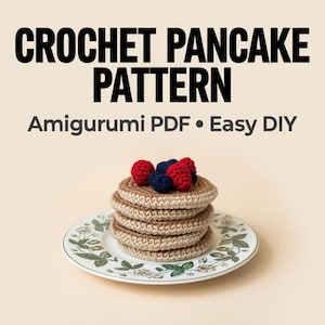 May include: A stack of crocheted pancakes topped with red and blue yarn berries, presented on a floral-patterned plate. The image includes the text "CROCHET PANCAKE PATTERN" and "Amigurumi PDF • Easy DIY".