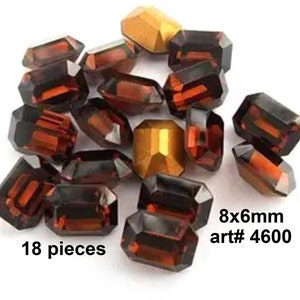 May include: 18 pieces of 8x6mm dark red and gold glass gems. art# 4600