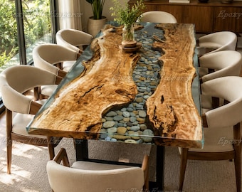 May include: A rectangular dining table featuring two large, natural-edged wood slabs separated by a central river-like inlay filled with smooth, multi-colored river stones encased in clear resin, supported by a black metal frame and eight chairs.