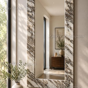 May include: A rectangular wall mirror featuring a thick frame with a white, brown, and black marble pattern. The mirror reflects an interior space with a wooden cabinet and a framed picture. The text Epoxy Table Emperor is visible on the frame.