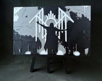 May include: A rectangular wall art piece featuring a layered black and white design. The center shows a silhouette of a figure with arms outstretched, positioned in front of a white geometric emblem with a circular halo and angular wing-like shapes.