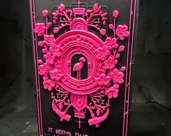May include: A rectangular black plaque featuring a raised neon pink relief design. The center displays a flamingo inside an arched frame surrounded by floral motifs and two scythes. The text reads: IT SEEMS THAT EVEN IN ARCADIA YOU WALK BESIDE ME STILL.