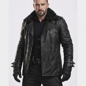 May include: A black leather jacket with a double-breasted design, a faux fur collar and multiple buckles. The jacket has a tailored fit and is worn with black gloves and trousers.