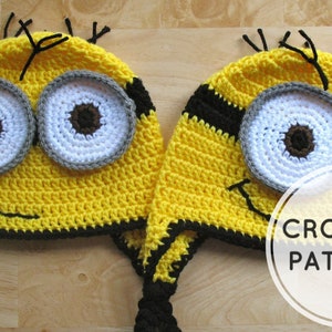 May include: Two yellow crochet hats with black earflaps and braided ties. One hat features two white eyes with brown pupils and gray rims, while the other has one eye. Both have black smiles and black yarn hair. Text reads CROCHET PATTERN.