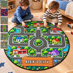 May include: A round play rug featuring a printed city map with gray roads, green trees, a school, a gas station, houses, and a fire station. A large wooden-style sign at the bottom displays the text ALEX'S CITY in bold black letters.