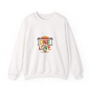 May include: White sweatshirt with a graphic design featuring the words "ONE LOVE" in red, green, and yellow, with a heart and musical notes. The design includes a sunset and palm trees.