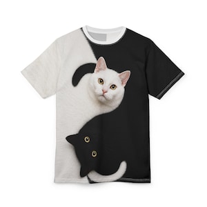 May include: A short-sleeve t-shirt featuring a yin-yang design composed of a white cat on a black background and a black cat on a white background. The cats are positioned in a circular formation, with the white cat at the top and the black cat at the bottom, creating a high-contrast graphic print across the front of the garment.