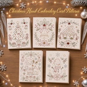 May include: Five off-white greeting cards featuring Christmas hand embroidery patterns including a decorated tree, a bell with poinsettias, a gingerbread house, Santa Claus with a reindeer, and a snowman, all outlined in red, green, and gold.
