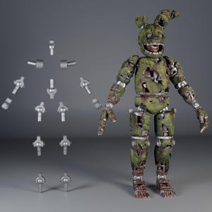 May include: A green and brown articulated figure of a rabbit-like character with exposed metal parts. The figure has a distressed appearance, with visible damage and wear. Several silver-colored joint pieces are displayed separately.
