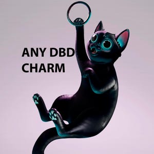 May include: A black cat figurine with large eyes and teal accents on its ears and paws, hanging from a circular ring. The text ANY DBD CHARM is printed in black to the left of the cat. The cat has a wide-eyed expression and a long tail.