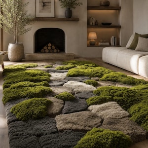 May include: A rectangular area rug with a unique design, featuring a pattern of gray, brown, and beige stones interspersed with vibrant green moss-like sections. The rug is placed on a wooden floor in a living room setting.