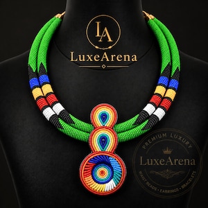 May include: A multi-strand beaded necklace featuring vibrant green, black, blue, yellow, red, and white seed beads. The necklace includes a large, three-part pendant with concentric circular and teardrop patterns in a rainbow of colors. Text reads LuxeArena.