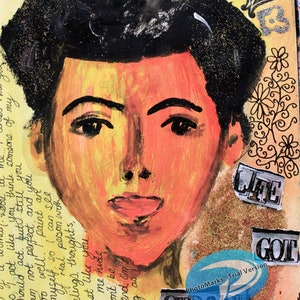 May include: Mixed media artwork featuring a painted portrait of a person with black hair and orange skin tones. The words "LIFE GOT STRANGE" are collaged on the artwork. The background includes handwritten text and decorative elements.