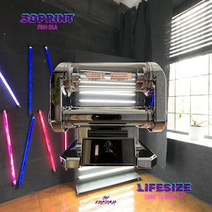 May include: A chrome-finished T-800 T2 CPU chip prop featuring a clear cylindrical housing with metallic internal components. The base includes a black rectangular plaque with a geometric logo. Text on the image reads 3DPRINT FDM-SLA, LIFESIZE, T800 T2 CPU V2, and By Krystyna.