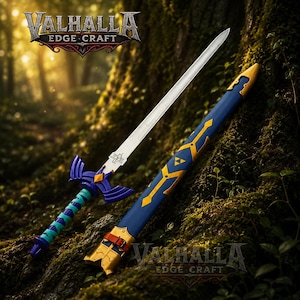 May include: A decorative sword with a silver blade and a blue and gold hilt and scabbard. The hilt has a teal and blue grip. The scabbard is blue with gold accents. The sword is displayed on a mossy tree trunk. The Valhalla Edge Craft logo is visible.