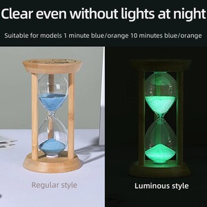 May include: An hourglass with a light-colored wooden frame and blue sand. The image displays two versions: a regular style with blue sand and a luminous style that glows in the dark. Text reads: Clear even without lights at night. Suitable for models 1 minute blue/orange 10 minutes blue/orange.