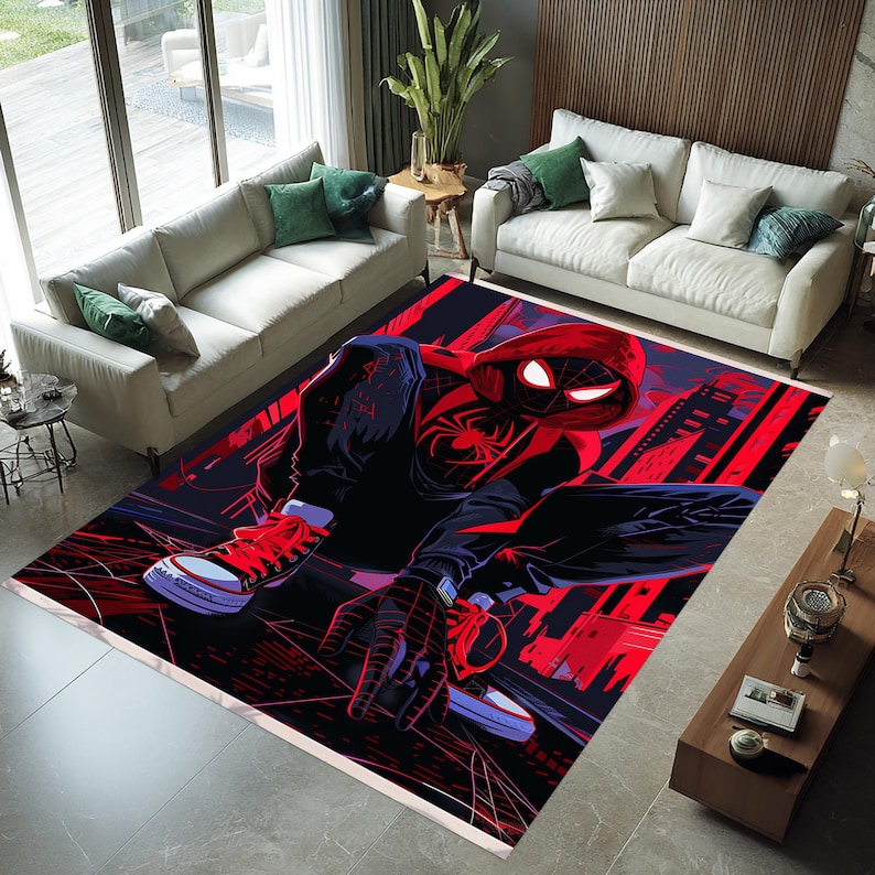 May include: A rectangular area rug featuring a comic book style illustration of a superhero in a black and red suit. The rug has a black background with red cityscapes and spiderweb designs. The superhero is crouched down, wearing red sneakers.
