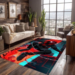 May include: A rectangular area rug featuring a dynamic illustration of a superhero in a red and black suit. The rug has a vibrant color palette of red, black, and teal, with a cityscape design. The rug is placed on a wooden floor.