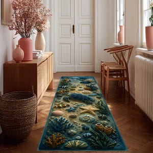 May include: A rectangular runner rug featuring a detailed underwater scene with a sea turtle, starfish, various seashells, coral formations, and a clownfish. The design displays a sandy ocean floor in shades of blue, yellow, and green.