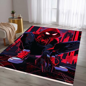 May include: A rectangular rug featuring a dynamic illustration of a superhero in a black and red suit, crouching low. The design includes a cityscape backdrop in red and black, with the superhero's eyes glowing. The rug has a white border.