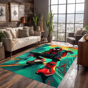 May include: A rectangular area rug featuring a superhero graphic in shades of red, black, green, and orange. The rug depicts a character in a dynamic pose, set against an abstract cityscape background. The rug is placed on a wooden floor.