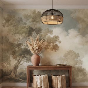 May include: An interior scene featuring a mural of a forest landscape with a wooden console table, two woven baskets, and a decorative vase with dried plants. A woven pendant light hangs from the ceiling, and a rug is on the floor.